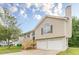 Two-story home featuring a two-car garage, inviting entrance, with a well-manicured lawn at 3022 Stonebridge Creek Dr, Lithonia, GA 30058