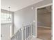 Hallway featuring a lantern light fixture, white trim and staircase to the second floor at 3022 Stonebridge Creek Dr, Lithonia, GA 30058