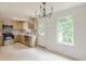 Modern kitchen featuring stainless steel appliances, wood cabinets, and a door to the backyard at 3022 Stonebridge Creek Dr, Lithonia, GA 30058