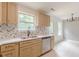 Bright kitchen with light cabinets, herringbone backsplash, and stainless steel appliances at 3022 Stonebridge Creek Dr, Lithonia, GA 30058