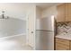 An open-concept area that displays the kitchen and its stainless steel refrigerator at 3022 Stonebridge Creek Dr, Lithonia, GA 30058