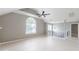 Bright living room featuring light wood floors, vaulted ceilings, and a large arched window at 3022 Stonebridge Creek Dr, Lithonia, GA 30058