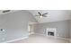 Bright living room with high ceilings, modern fan, fireplace, and light wood floors at 3022 Stonebridge Creek Dr, Lithonia, GA 30058