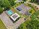 Aerial view of community amenities including pool, tennis court, playground and covered picnic area surrounded by trees and grass at 47 Centerport Dr, White, GA 30184