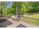 Enjoy backyard views from the deck with a patio heater, seating, and mature trees at 47 Centerport Dr, White, GA 30184