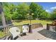 Great backyard views from the deck with a patio heater, seating and a play set at 47 Centerport Dr, White, GA 30184