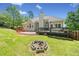 Spacious yard features a swing set, fire pit, manicured lawn and a large wooden deck at 47 Centerport Dr, White, GA 30184