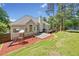 Large backyard with a swing set, trampoline, deck, and lush green grass for outdoor fun at 47 Centerport Dr, White, GA 30184