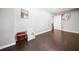 Light filled bedroom with dark hardwood floors, a whimsical clock and a charming accent chair at 47 Centerport Dr, White, GA 30184