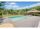 Community pool with a clean and well-maintained deck, complete with a gazebo and ample seating at 47 Centerport Dr, White, GA 30184