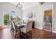 Elegant dining room with hardwood floors, large windows, and a stylish chandelier lighting the dining table at 47 Centerport Dr, White, GA 30184