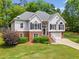 Inviting two-story home showcasing a blend of brick and stucco, set on a well-maintained lawn at 47 Centerport Dr, White, GA 30184