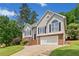 Attractive home exterior featuring a blend of brick and stucco, complemented by a lush, green lawn at 47 Centerport Dr, White, GA 30184
