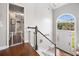 Bright foyer with hardwood floors, staircase, and an arched window above the front door at 47 Centerport Dr, White, GA 30184