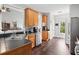 Well-designed kitchen with stainless steel appliances, wooden cabinets, and hardwood floors at 47 Centerport Dr, White, GA 30184