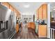 Open kitchen with stainless steel appliances, wood cabinets and view to breakfast table at 47 Centerport Dr, White, GA 30184