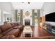 Spacious living room boasts hardwood floors, a brick fireplace, and ample natural light at 47 Centerport Dr, White, GA 30184