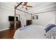 Main bedroom features hardwood floors, ceiling fan and large TV at 47 Centerport Dr, White, GA 30184