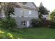 Back exterior view of house with door entrance to basement and grassy lawn at 1699 Little Fox Ln, Dacula, GA 30019