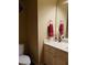 Powder room featuring a white vanity, toilet, and towel holder, ideal for guests at 1699 Little Fox Ln, Dacula, GA 30019