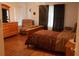 Inviting bedroom with a wooden bed, comfortable chair, and stylish curtains for a cozy retreat at 1699 Little Fox Ln, Dacula, GA 30019