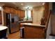 Warm kitchen with wooden cabinets, stainless steel appliances, and hardwood floors at 1699 Little Fox Ln, Dacula, GA 30019