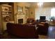 Comfortable living room with a fireplace, built-in bookcases, and plush leather seating at 1699 Little Fox Ln, Dacula, GA 30019