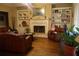 Inviting living room with a fireplace, built-in bookcases, and comfortable leather furniture at 1699 Little Fox Ln, Dacula, GA 30019