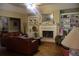Bright living room featuring a fireplace, built-in shelving, and a comfortable leather sofa at 1699 Little Fox Ln, Dacula, GA 30019