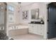 Bathroom featuring a soaking tub, vanity, and natural light from the window at 190 Centennial Way, Atlanta, GA 30313