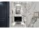 This modern bathroom features marble walls, a floating vanity, and sleek fixtures at 190 Centennial Way, Atlanta, GA 30313