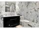 This modern bathroom features marble walls and floors, a sleek vanity, and glass shower at 190 Centennial Way, Atlanta, GA 30313