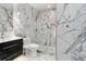 This elegant bathroom features marble walls and floors, a glass shower, and modern fixtures at 190 Centennial Way, Atlanta, GA 30313