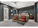 Spacious bedroom featuring patterned carpeting, ceiling fan, stylish decor, and leather chairs at 190 Centennial Way, Atlanta, GA 30313