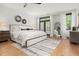 Bright bedroom featuring a ceiling fan, wood floors, and natural light at 190 Centennial Way, Atlanta, GA 30313