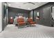 Spacious bedroom featuring patterned carpeting, ceiling fan, stylish decor, and leather chairs at 190 Centennial Way, Atlanta, GA 30313