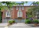 Beautiful exterior view of townhomes with brick facade, bay windows, and a well-manicured lawn at 190 Centennial Way, Atlanta, GA 30313