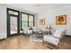 Stylish living room with hardwood floors, modern chairs, and natural light from the glass doors at 190 Centennial Way, Atlanta, GA 30313
