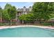 An inviting community pool surrounded by lounge chairs, lush greenery and shade trees at 190 Centennial Way, Atlanta, GA 30313