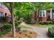 Scenic walkway lined with lush greenery and trees leading to the charming community at 190 Centennial Way, Atlanta, GA 30313