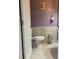 Bathroom featuring tiled floors, toilet and lavender colored walls at 209 Kingscastle Dr, Ellenwood, GA 30294