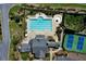 Aerial view of the luxurious pool, sun loungers, and pristine tennis courts at 34 Mountainbrook Nw Dr, Cartersville, GA 30121