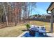 Expansive backyard featuring a patio with outdoor seating and lush greenery, ideal for relaxation at 34 Mountainbrook Nw Dr, Cartersville, GA 30121