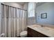 This full bathroom has a dark vanity and a window above the commode at 34 Mountainbrook Nw Dr, Cartersville, GA 30121