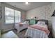 Bedroom features two beds, a decorative wall, and a window at 34 Mountainbrook Nw Dr, Cartersville, GA 30121