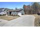 Home featuring a concrete driveway and well-manicured lawn at 34 Mountainbrook Nw Dr, Cartersville, GA 30121
