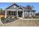 Inviting single story home with manicured lawn, charming front porch, and craftsman details at 34 Mountainbrook Nw Dr, Cartersville, GA 30121