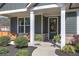 Inviting front porch with seating, plants, and a charming wreath on the front door at 34 Mountainbrook Nw Dr, Cartersville, GA 30121