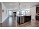 Open-concept kitchen featuring a dark island, stainless steel appliances, and seamless flow to the living area at 34 Mountainbrook Nw Dr, Cartersville, GA 30121