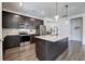 Modern kitchen featuring dark cabinetry, granite countertops, stainless steel appliances, and an open layout design at 34 Mountainbrook Nw Dr, Cartersville, GA 30121